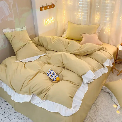 Cozy mustard-yellow duvet cover set with white ruffled trim and matching pillows in a warmly lit bedroom setting