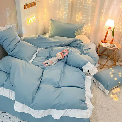 Light blue quilted duvet cover set with white ruffle trim for bedroom bedding with elegant design