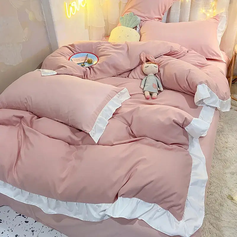 Pink ruffled duvet cover set with white trim for bedroom bedding featuring quilted light blue and white ruffle accents