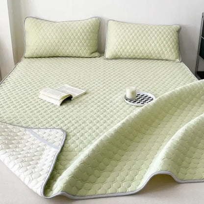 Light green quilted decorbites cooling mat with honeycomb texture and white piping for bedroom bedding use