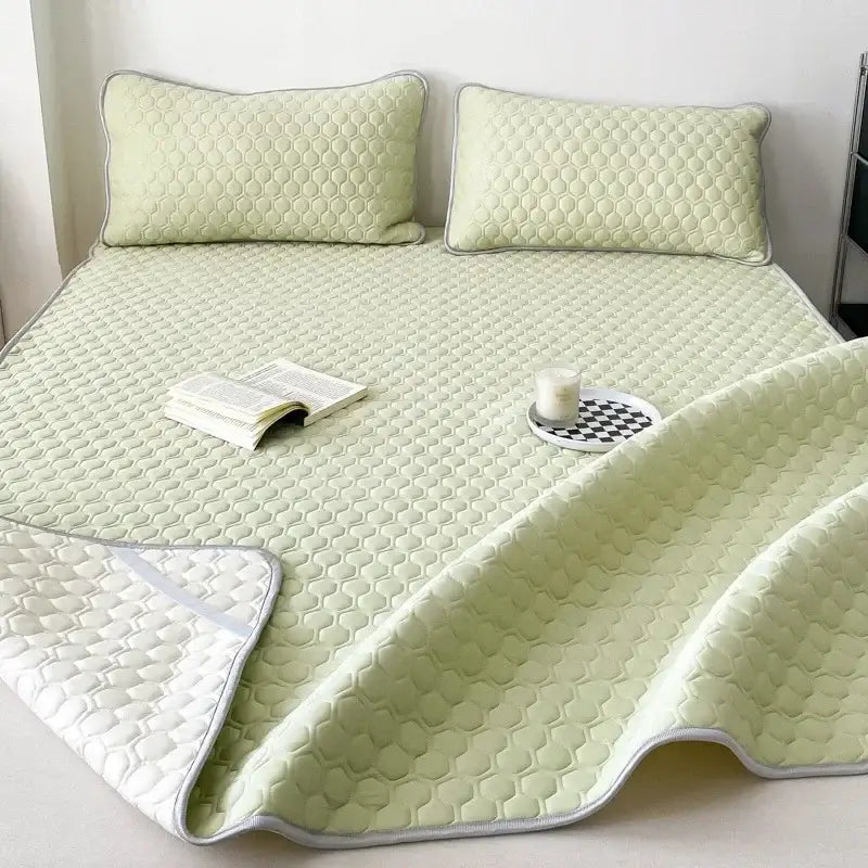 Quilted light green decorbites cooling mat with honeycomb texture and white piping for bedroom bedding set