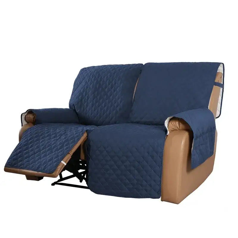 Navy blue quilted fabric sofa protector with brown leather trim designed for living room recliner slipcover use