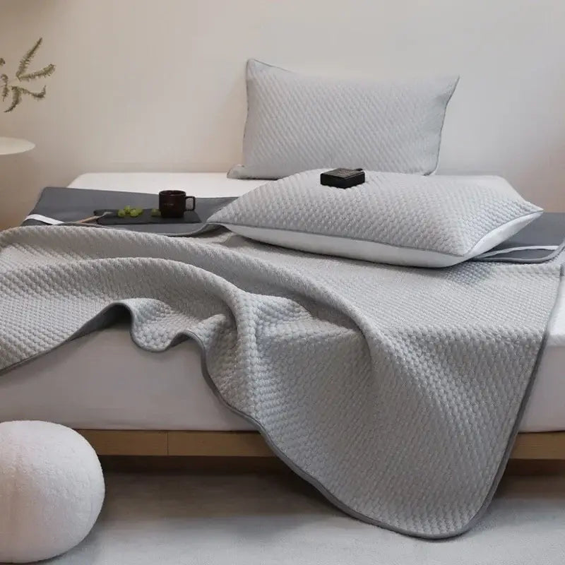 Gray quilted bedspread with subtle texture and finished edges in decorbites ice bean cooling mat pillowcase set