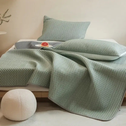 Light green quilted bedspread with woven texture and plush appearance in decorbites ice bean cooling mat pillowcase set