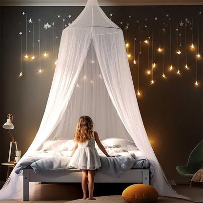 A delicate white sheer hanging mosquito net with star lights flows elegantly above the bed as a bedroom canopy