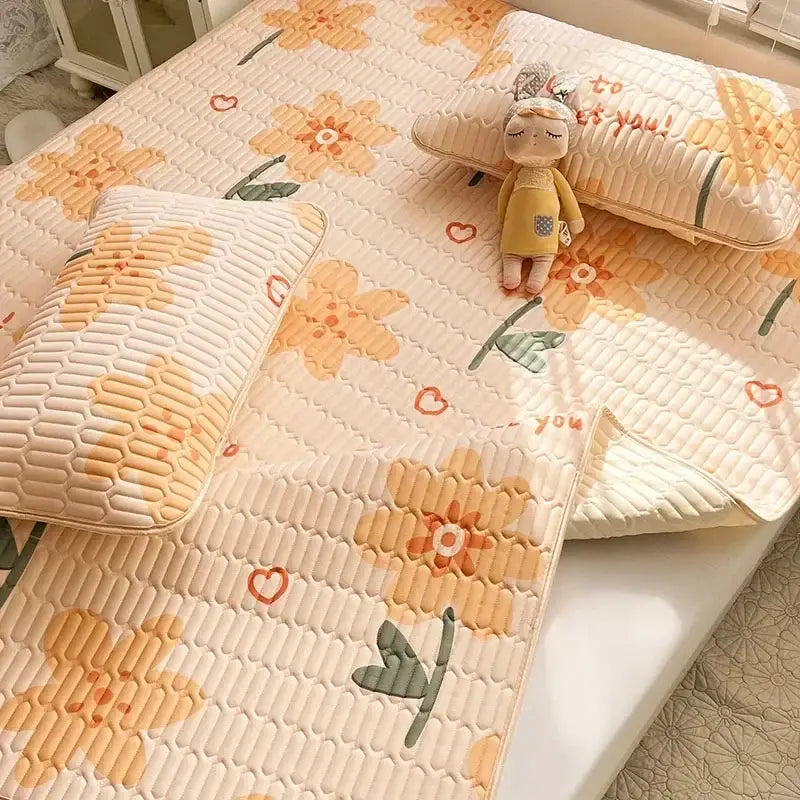 Cream-colored quilted bed pad with embroidered orange flowers and red hearts for decorbites cartoon print mattress set