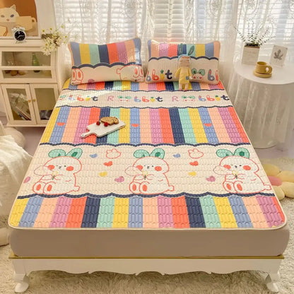 Rainbow striped quilted cooling mattress pad with decorbites cartoon print featuring rabbits in cream mattress set