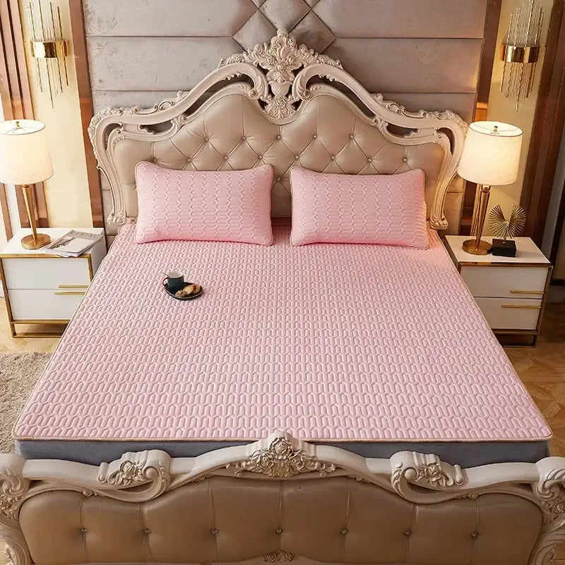 Pink quilted mattress pad with subtle texture on ornate bed frame part of decorbites cartoon print mattress set