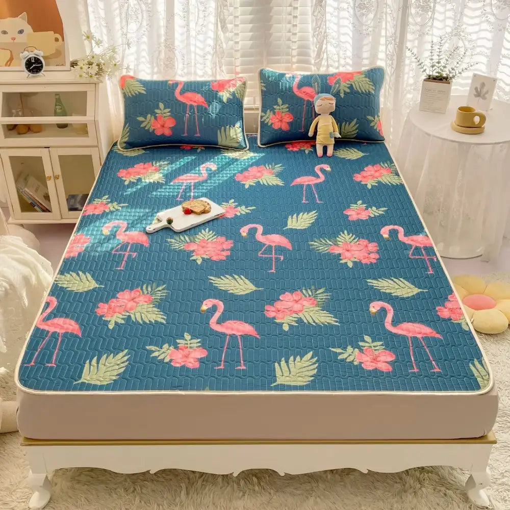 Blue quilted bed pad with pink flamingo and floral patterns in a decorbites cartoon print mattress set