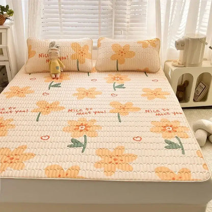 Cream-colored quilted bed pad with cheerful yellow flower pattern and nice to meet you text for decorbites cartoon print mattress set
