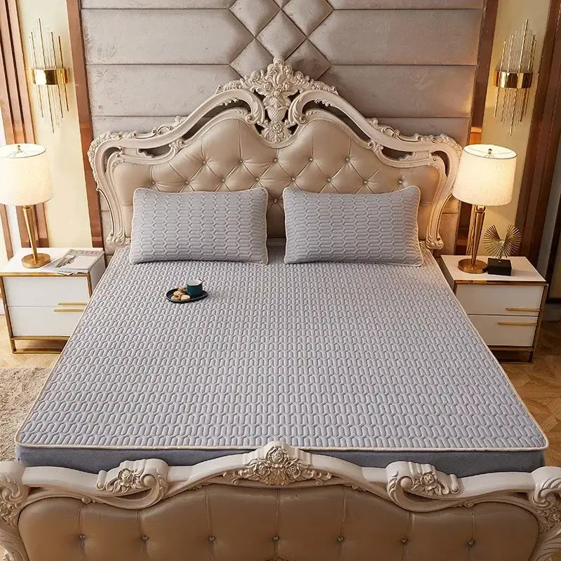 Light gray quilted mattress pad with subtle texture on ornate bed frame complementing decorbites cartoon print mattress set