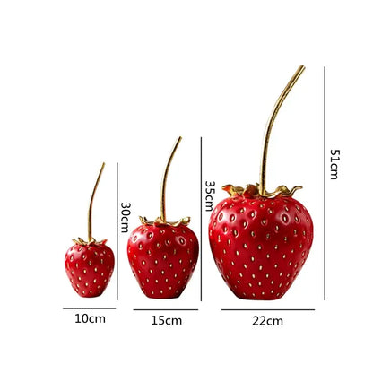 Three glossy red home decor strawberry figurines with gold stems and leafy tops decorbites gold strawberry theme