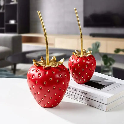 Two glossy red resin strawberry figurines with gold leaf stems and seeds for home decor or decorbites gold strawberry accents