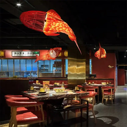 Red bamboo fish pendant light with woven texture and glowing interior for living room decorbites bamboo fish decor