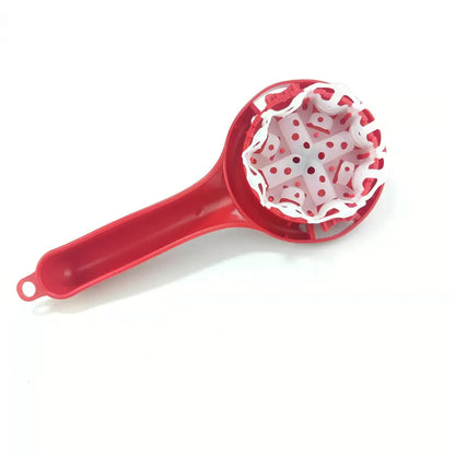 Red plastic fruit corer with white perforated inner mechanism used as a cleaning tool for espresso coffee machines