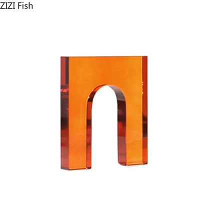 Transparent orange acrylic letter n charm complementing red and blue geometric crystal arch glass sculpture decor