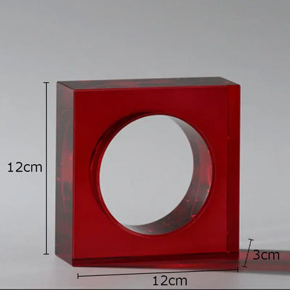Red translucent acrylic square vase with central circular opening in a red and blue crystal arch glass sculpture decor
