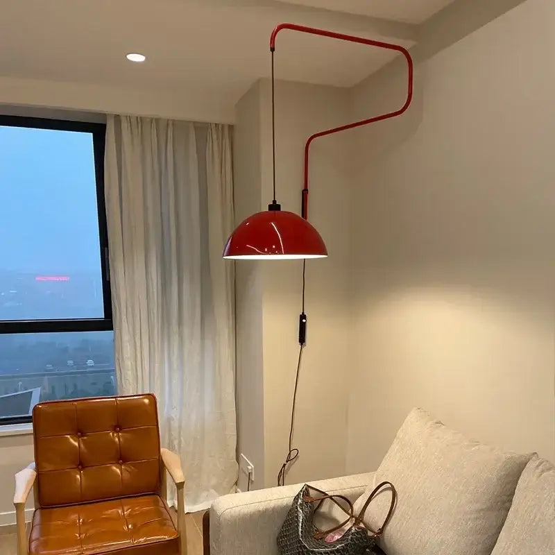 Red enamel dome adjustable pendant light with curved metal arm and glossy finish for kitchen island lighting