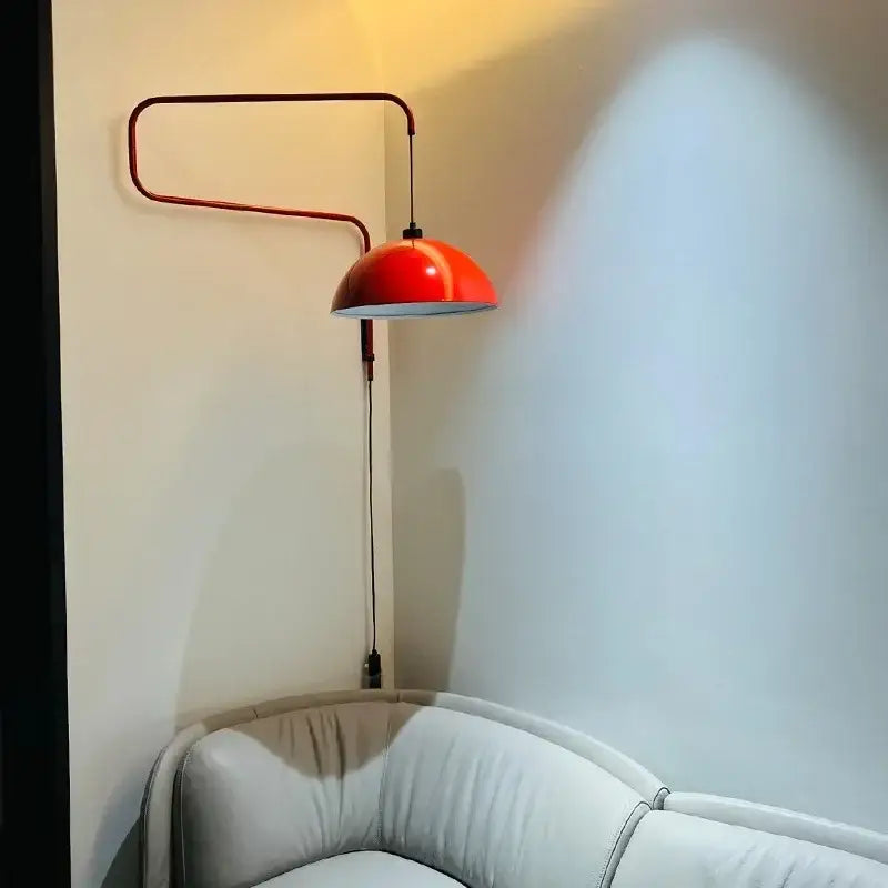 Vibrant red enamel dome adjustable pendant light with sleek curved metal arm ideal for kitchen island lighting