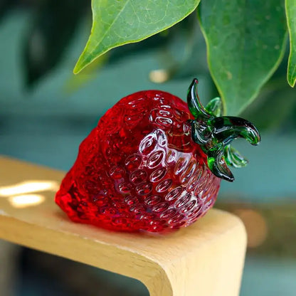 Red glass strawberry figurine with vibrant crystal fruit body and detailed green leafy stem for kitchen decor