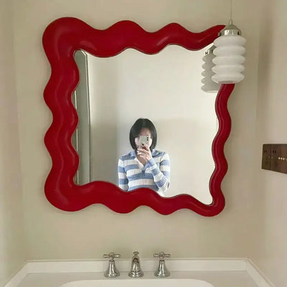 Vibrant red glossy cream cloud wave mirror with wavy edges for bedroom makeup decor by decorbites cream cloud
