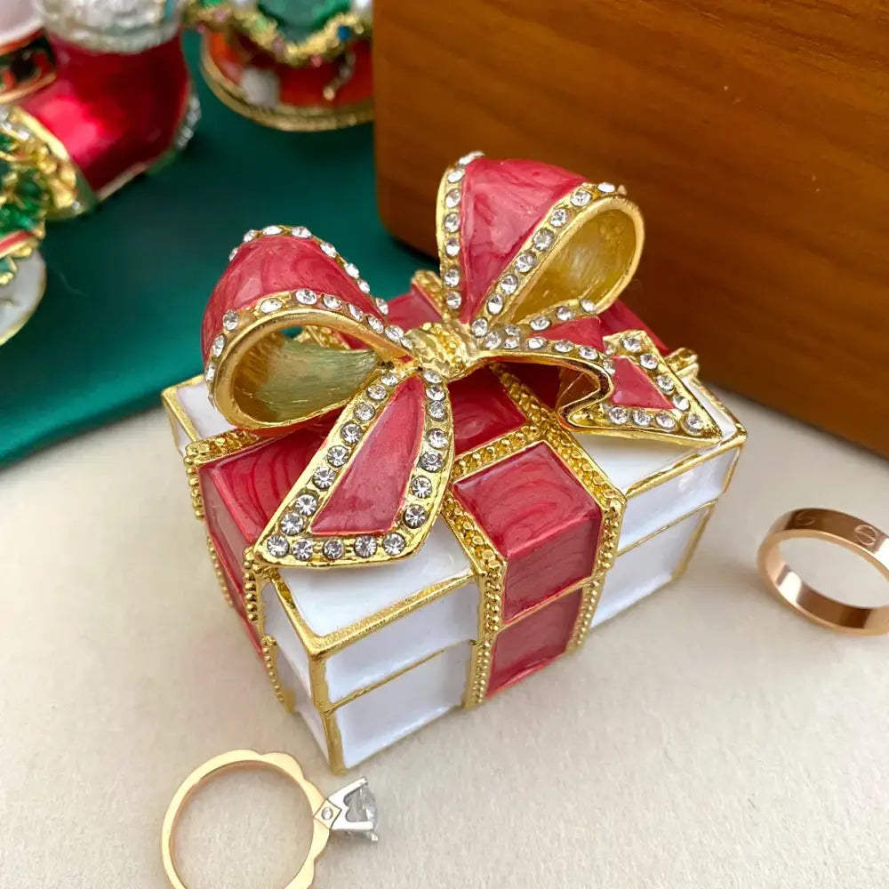 A red and white jewelry trinket box with a gold-trimmed bow studded with clear crystals for bedroom gift use