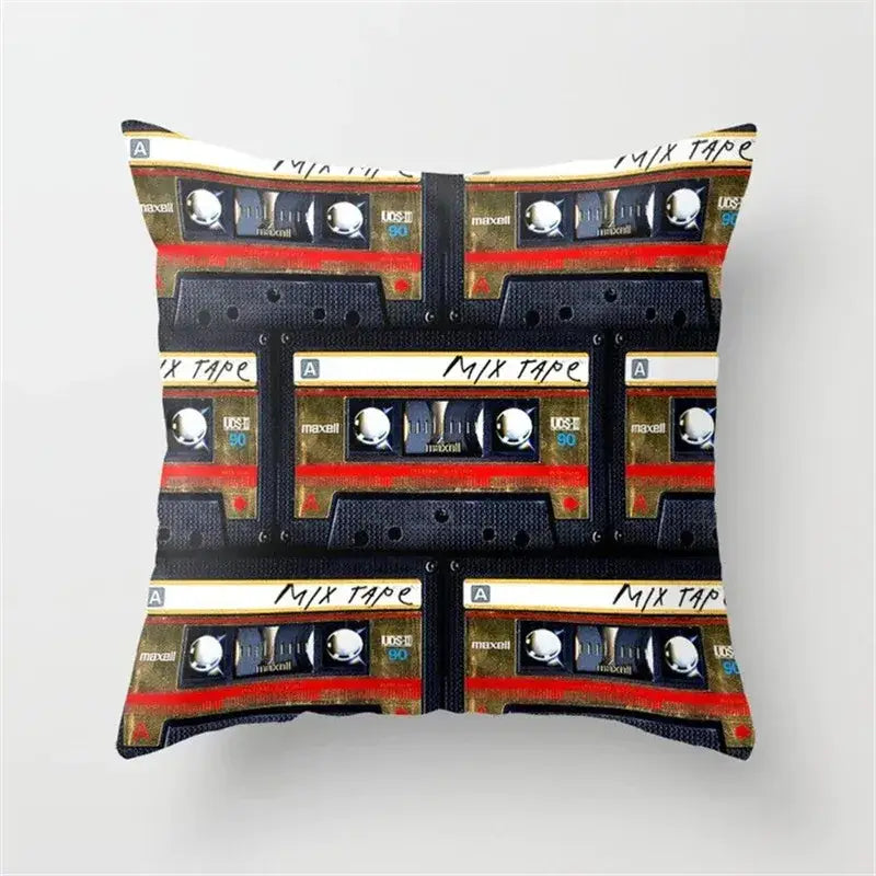Square cushion cover featuring a retro black camera print with vintage maxell cassette tapes in black, gold, and red accents