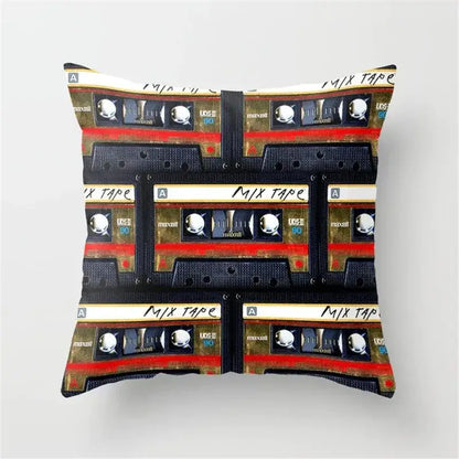 Square cushion cover featuring a retro black camera print with vintage maxell cassette tapes in black, gold, and red accents