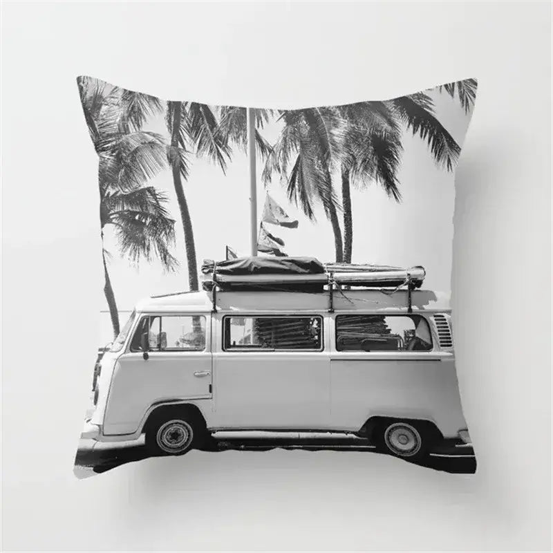 Black and white cushion cover with vintage volkswagen van and palm trees featuring a retro black camera print design