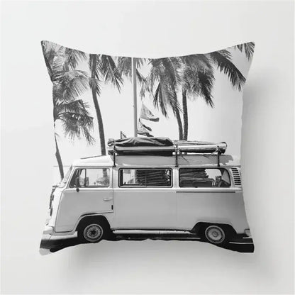Black and white cushion cover with vintage volkswagen van and palm trees featuring a retro black camera print design
