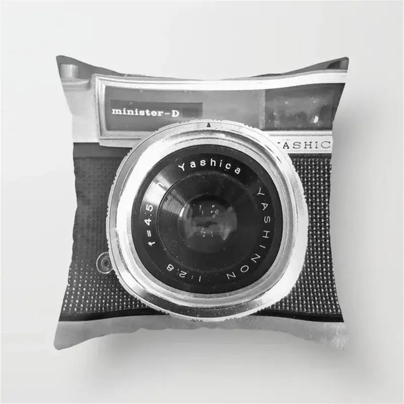 Black and white cushion cover featuring a vintage yashica black camera print with silver lens details for living room decor