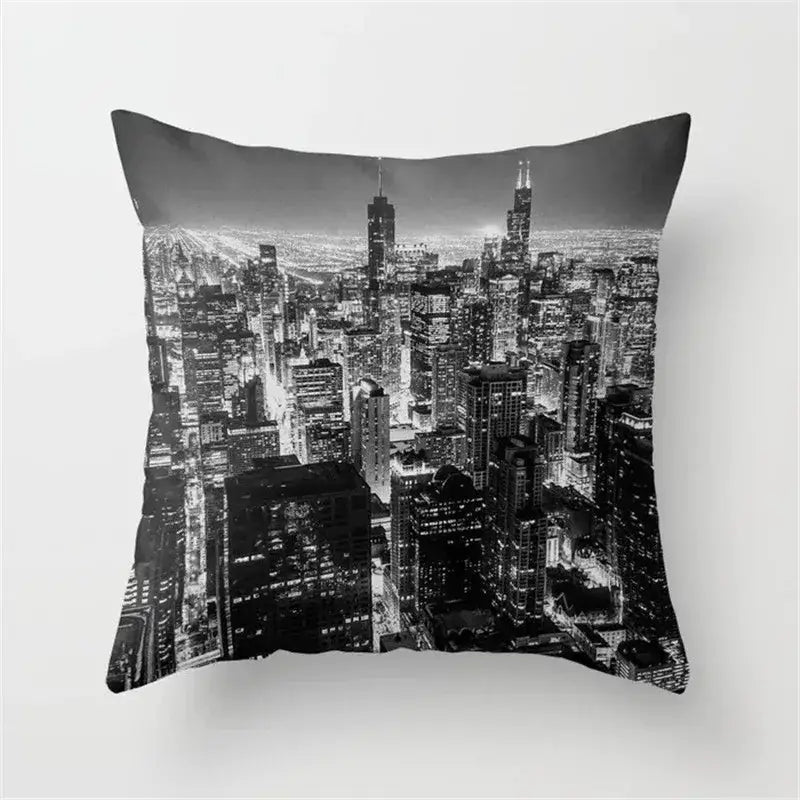 Black and white cushion cover featuring a high-contrast city skyline print with retro black camera design for living room decor