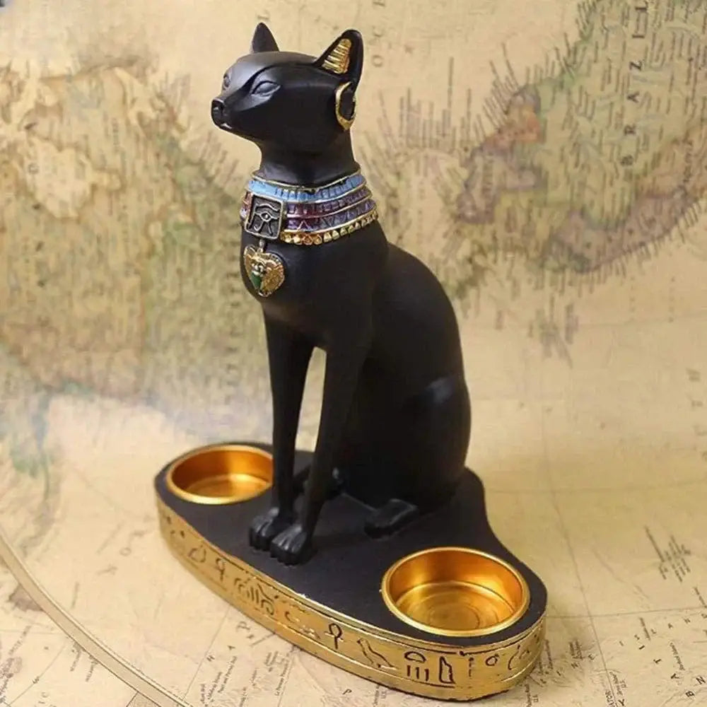 Retro black resin cat goddess candle holder with gold accents and ornate collar seated on base with two golden candle holders