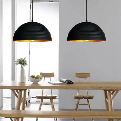 Retro black and gold semicircle pendant light with ribbed black pot cover and warm gold interior for dining room decorbites pendant light