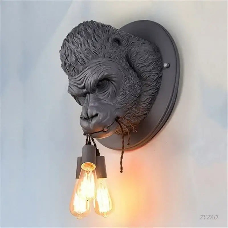 Dark gray retro black gorilla resin wall sconce with dual filament bulbs hanging from the mouth for decorbites gorilla resin wall decor