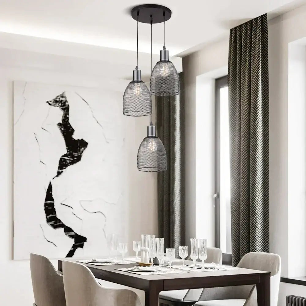 Three modern black metal cage bell pendant lights with mesh shades hang from a circular mount for dining room decorbites cage bell pendant