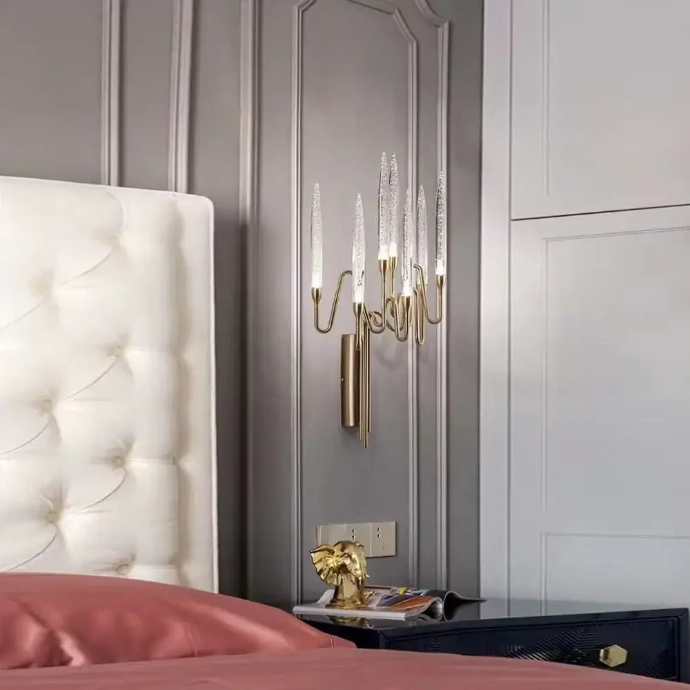 Gold-toned wall sconce with five crystal candle wall shades complements retro black rattan chair with puma cushion decorbites crystal candle