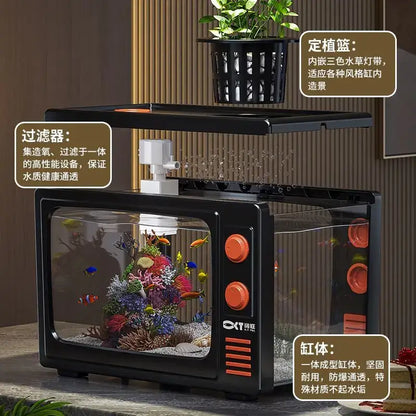 Retro black tv desktop fish tank with orange knobs and glass sides showcasing colorful fish and coral reef decorbites desktop fish