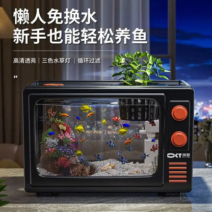 Retro black tv desktop fish tank with orange knobs and vents featuring colorful fish in a clear glass aquarium decorbites desktop fish