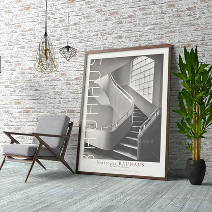 A framed black and white bauhaus stairs canvas print featuring bold vertical lettering for living room wall art