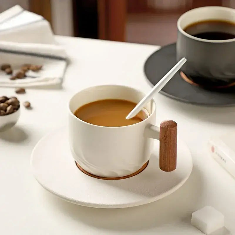 White ceramic coffee cup with wooden handle and saucer featuring textured detailing from decorbites 130ml blue set