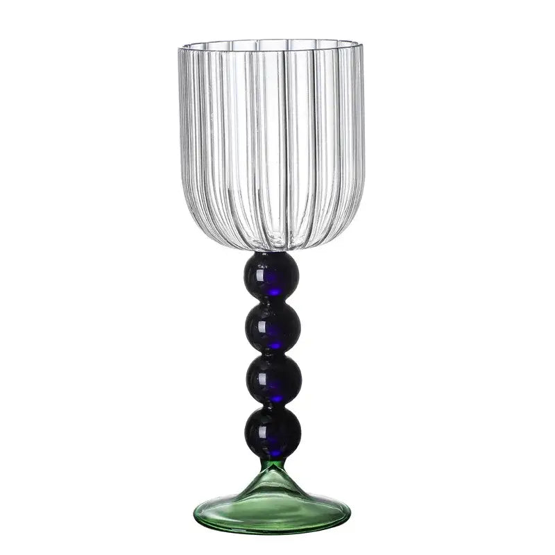 Clear glass wine glass with vertical ribbed texture, blue bead glass twister stem, and green-tinted base for dining