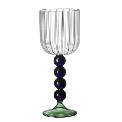 Clear glass wine glass twister with vertical ribbed texture, blue beads on stem, and green-tinted base for dining room use