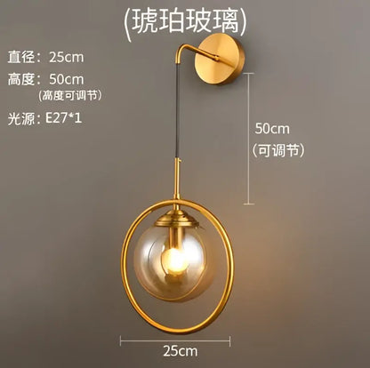 Gold-toned retro brass wall lamp with amber decorbites glass ball led and adjustable height for bathroom sconce lighting