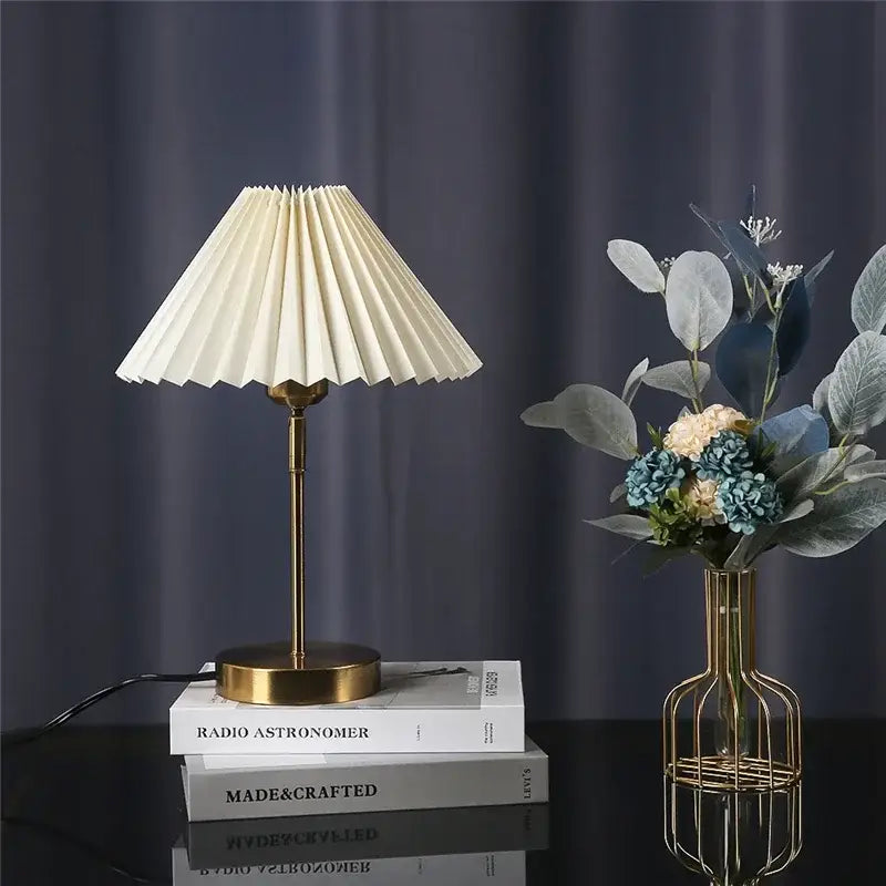 Cream-colored pleated table lamp with brass-finished base and stem from decorbites adjustable pleated collection for bedroom decor