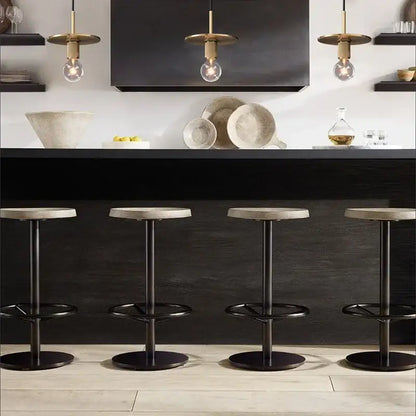 Four modern bar stools with black metal frames and gray concrete seats paired with retro brass and glass pendant light decorbites gold led