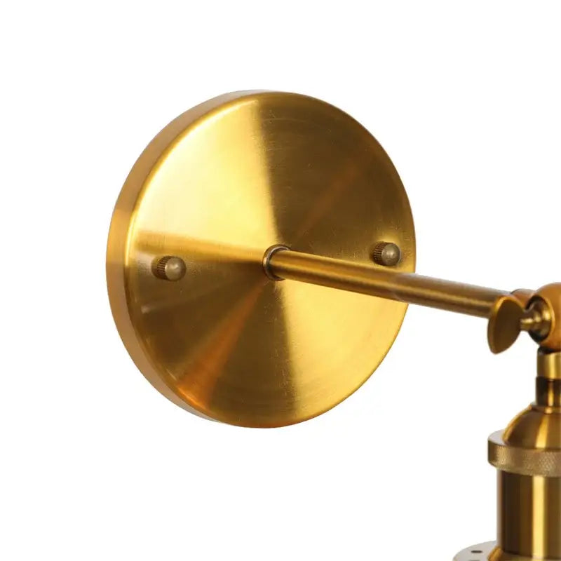 Brass-finished adjustable wall sconce with circular mounting plate and articulated arm for decorbites gold led wall lighting