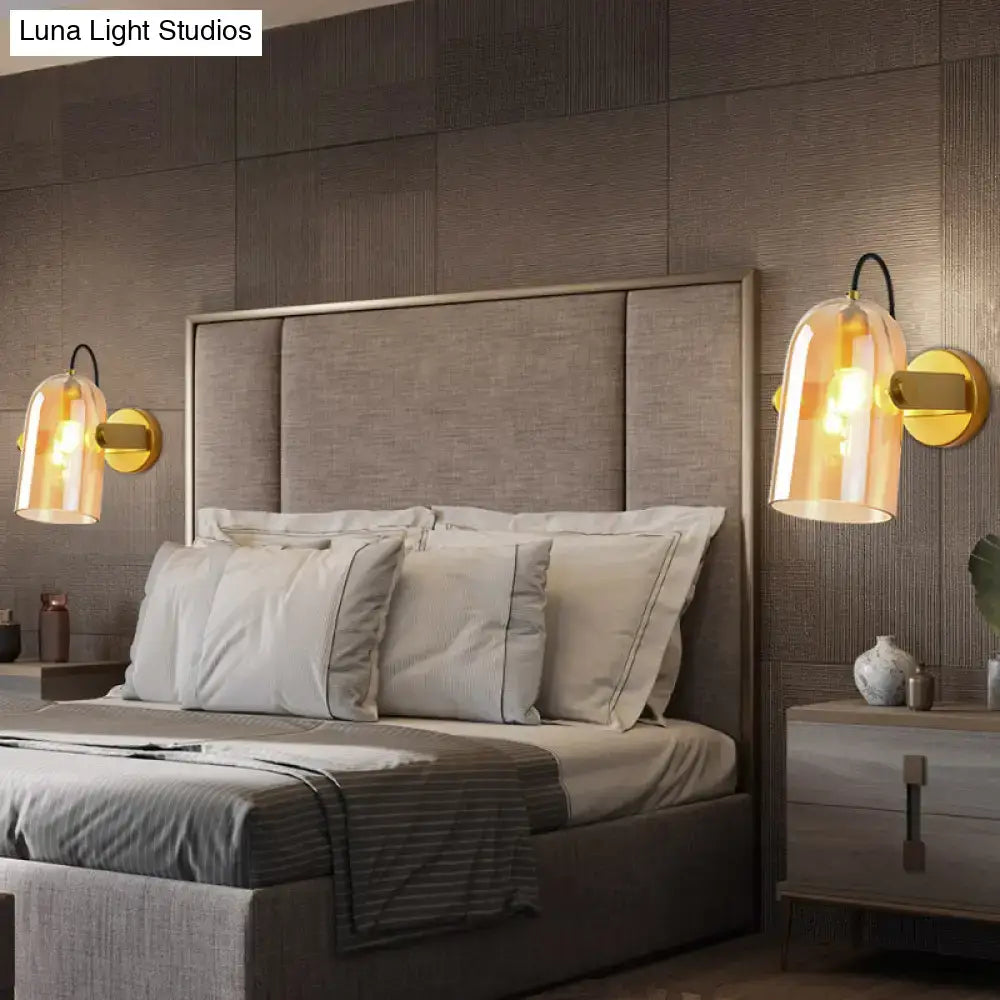 Gold-toned retro brass cloche sconce light with amber glass shades for bedroom featuring elegant cloche sconce light design