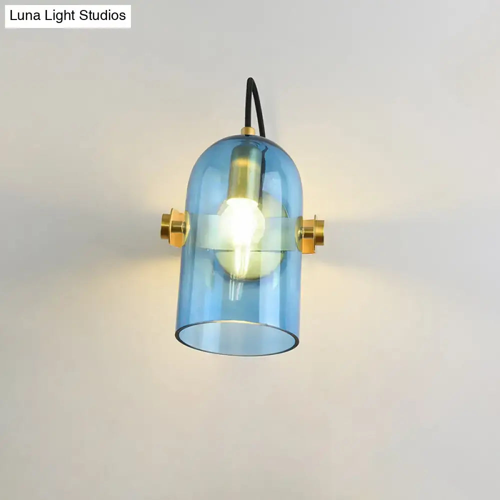 Retro brass cloche sconce light with blue glass pendant and brass accents for bedroom lighting use