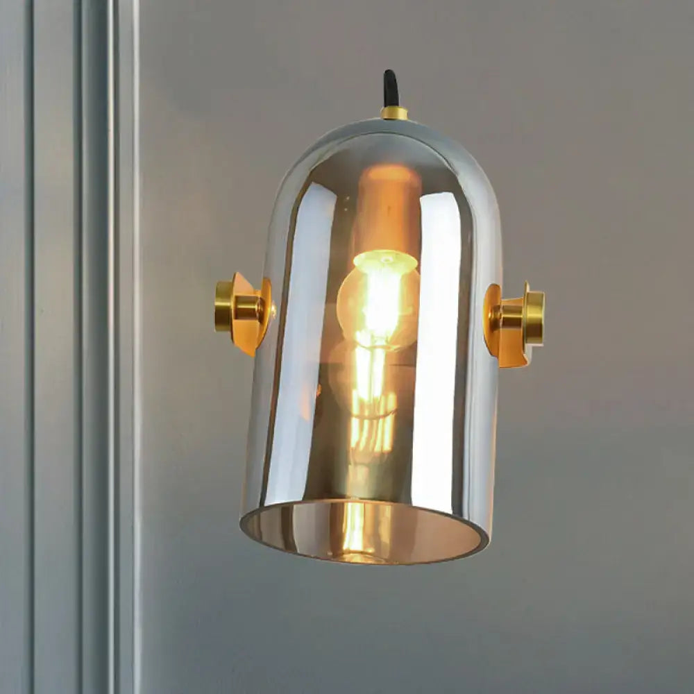 Retro brass cloche sconce light with blue glass and chrome finish featuring gold accents and exposed filament bulb